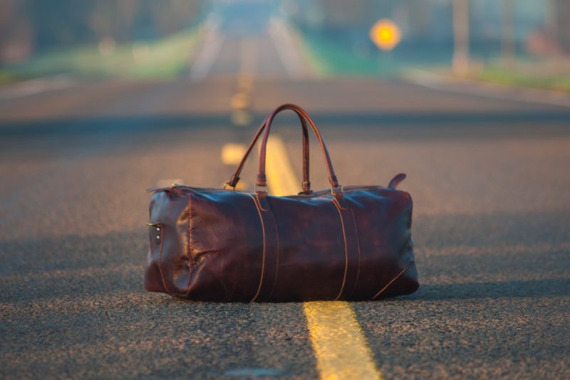 brown leather bag in the road